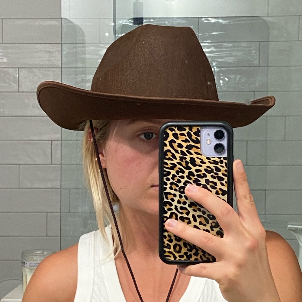 Brown cowboy hat.